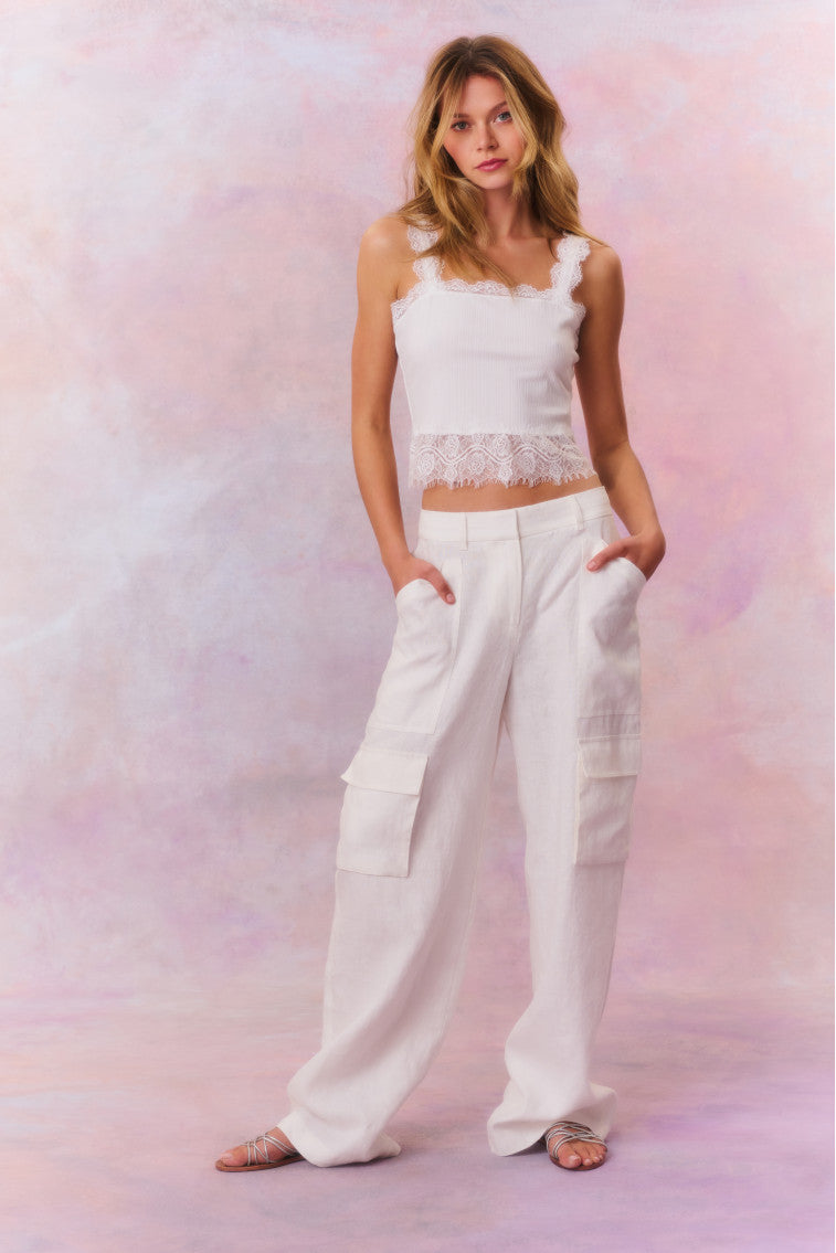 Linen straight leg cargo pants featuring pockets on each leg and on the side, and a center front zipper.
