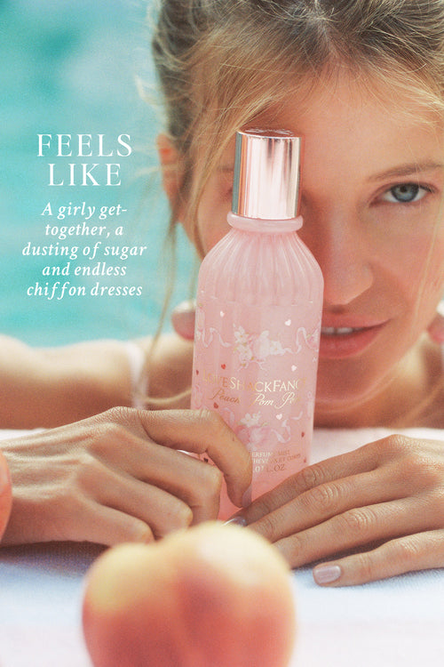 Pink bottle with decorative elements held by a person, with a blurred background and text overlay.