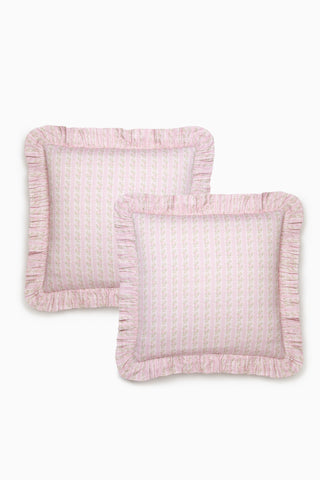 Two pink textured pillows with ruffled edges on a white background