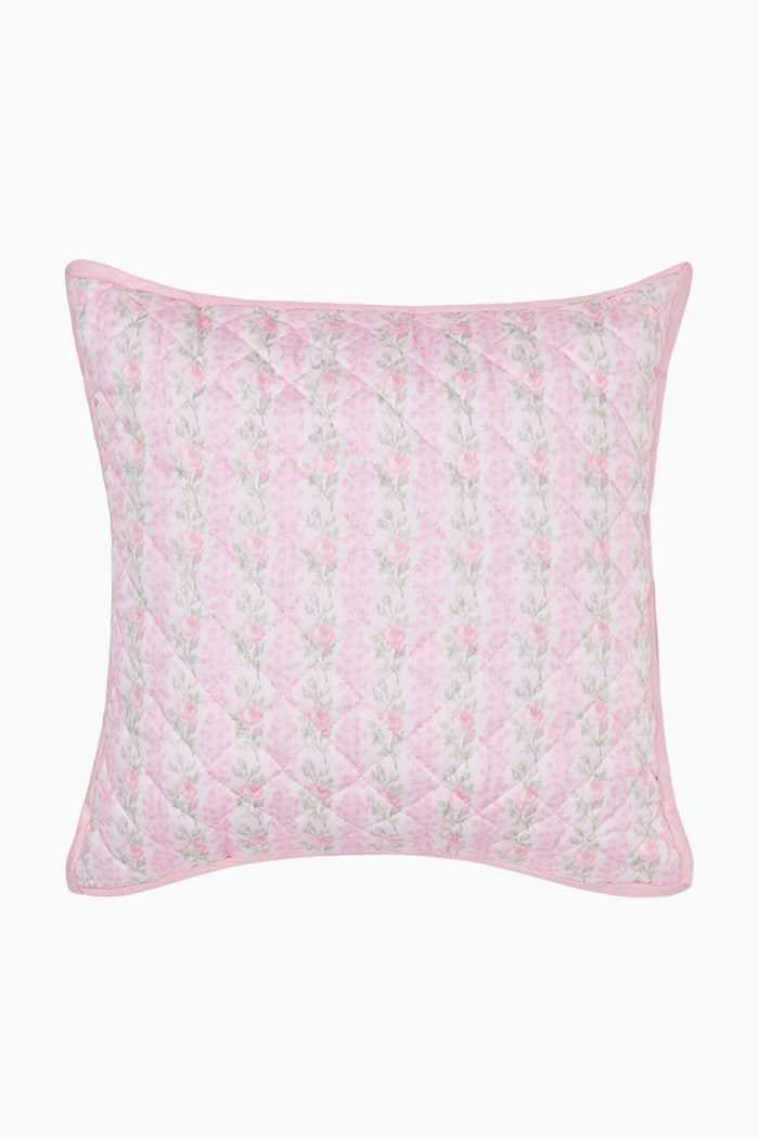 Pink floral quilted pillow on a white background