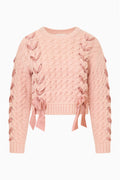 Pink textured knit pullover with crew neckline and ribbons laced down the front and bows at the hem
