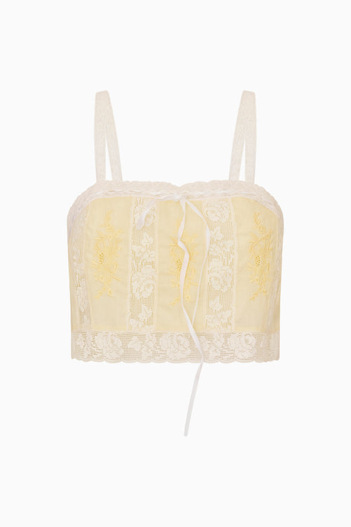 White lace trim yellow cotton cropped camisole against a white background