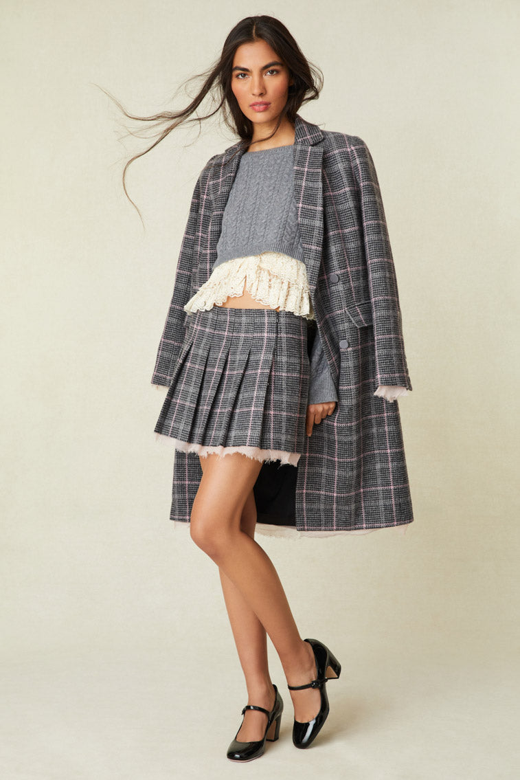 Gray Plaid mini skirt with  inward box pleated skirt has a fixed waist, a chiffon bias trim at the hem, and a side seam zipper. 