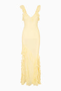 Yellow evening gown with ruffled details on a white background