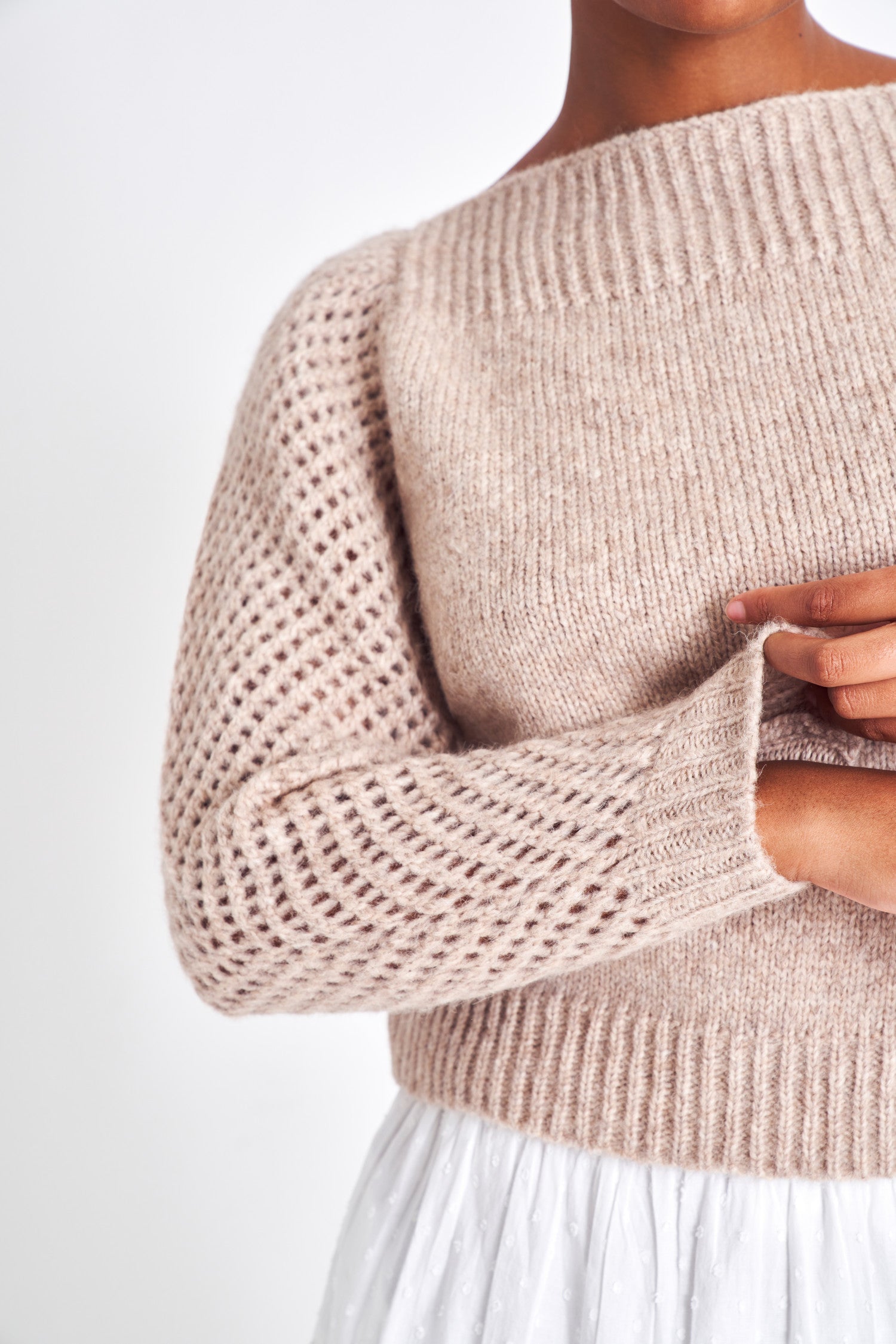 The Rosie oatmeal  pullover is made from baby alpaca while being extremely light and full with a chunky look. It has a straight rib neckline and a straight body with rib finishing. It is an open knit weave with a puffy shoulder that slims out at the bottom. 