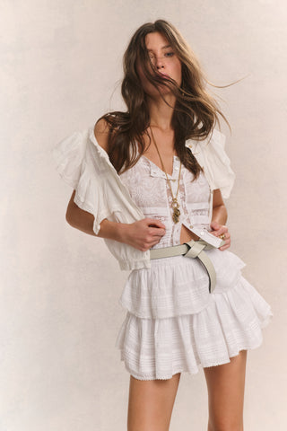 White ruffle mini skirt with layered tiers and elastic waistband