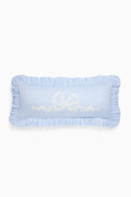 Light blue decorative pillow with ruffled edges and embroidered text on a white background