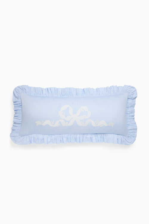 Light blue decorative pillow with ruffled edges and embroidered text on a white background