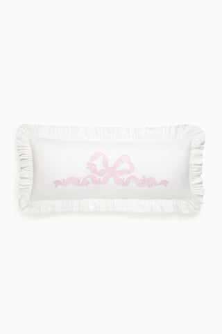 White pillow with pink text on a white background