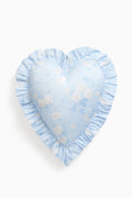 Heart-shaped pillow with blue and white floral pattern on a white background