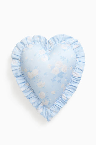 Heart-shaped pillow with blue and white floral pattern on a white background