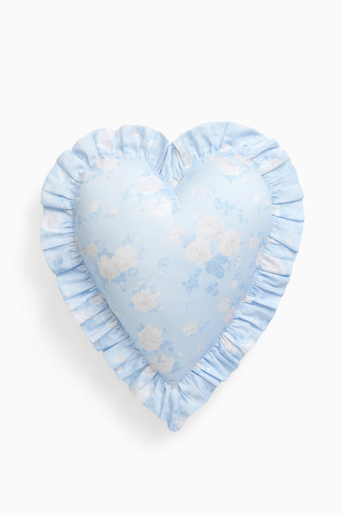 Heart-shaped pillow with blue and white floral pattern on a white background