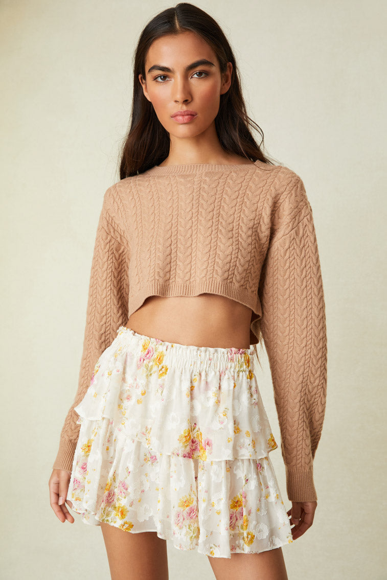 Floral mini skirt features intricate inset lace trims.