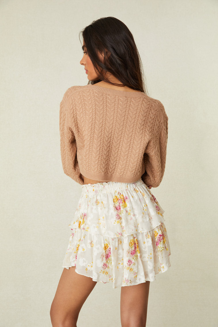 Floral mini skirt features intricate inset lace trims.