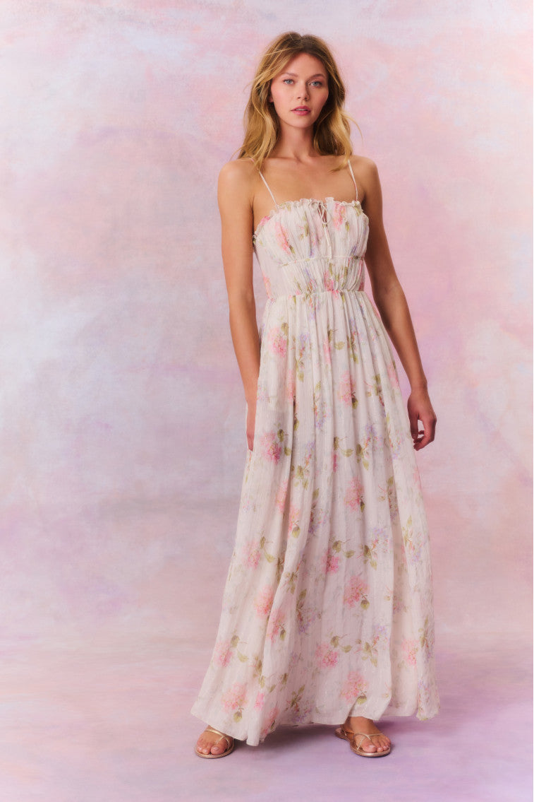 Maxi dress with ruched detailing at the top with ruffle detail at the neckline. The piece is finished with a sweeping shirred skirt and a smocked back for an easy and comfortable fit.