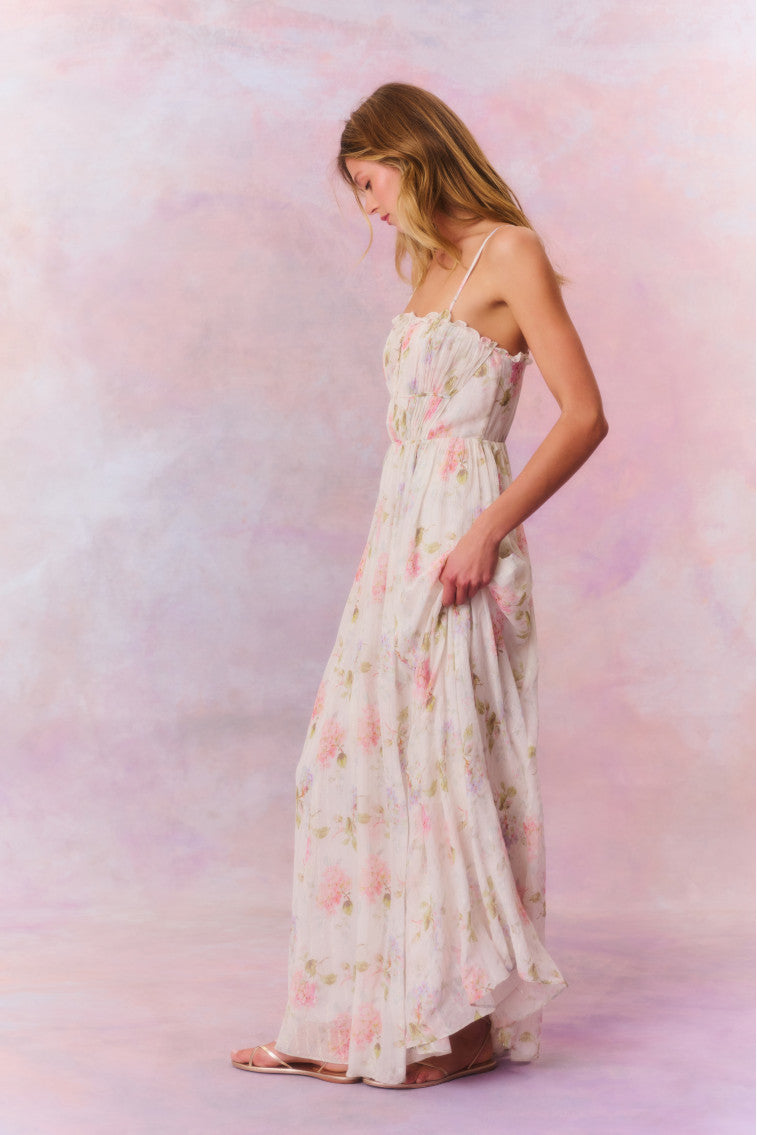 Maxi dress with ruched detailing at the top with ruffle detail at the neckline. The piece is finished with a sweeping shirred skirt and a smocked back for an easy and comfortable fit.