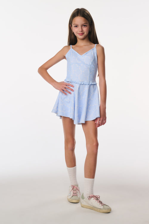 Young girl wearing a light blue dress on a white background