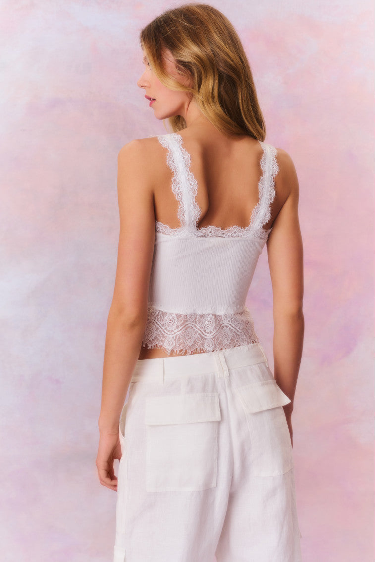 White cami top with lace trim along the bottom, the necklines, and the straps.