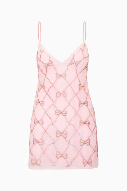 Pink lace mini dress with bow pattern embellishments on a white background