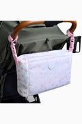Stroller organizer with floral pattern attached to a stroller