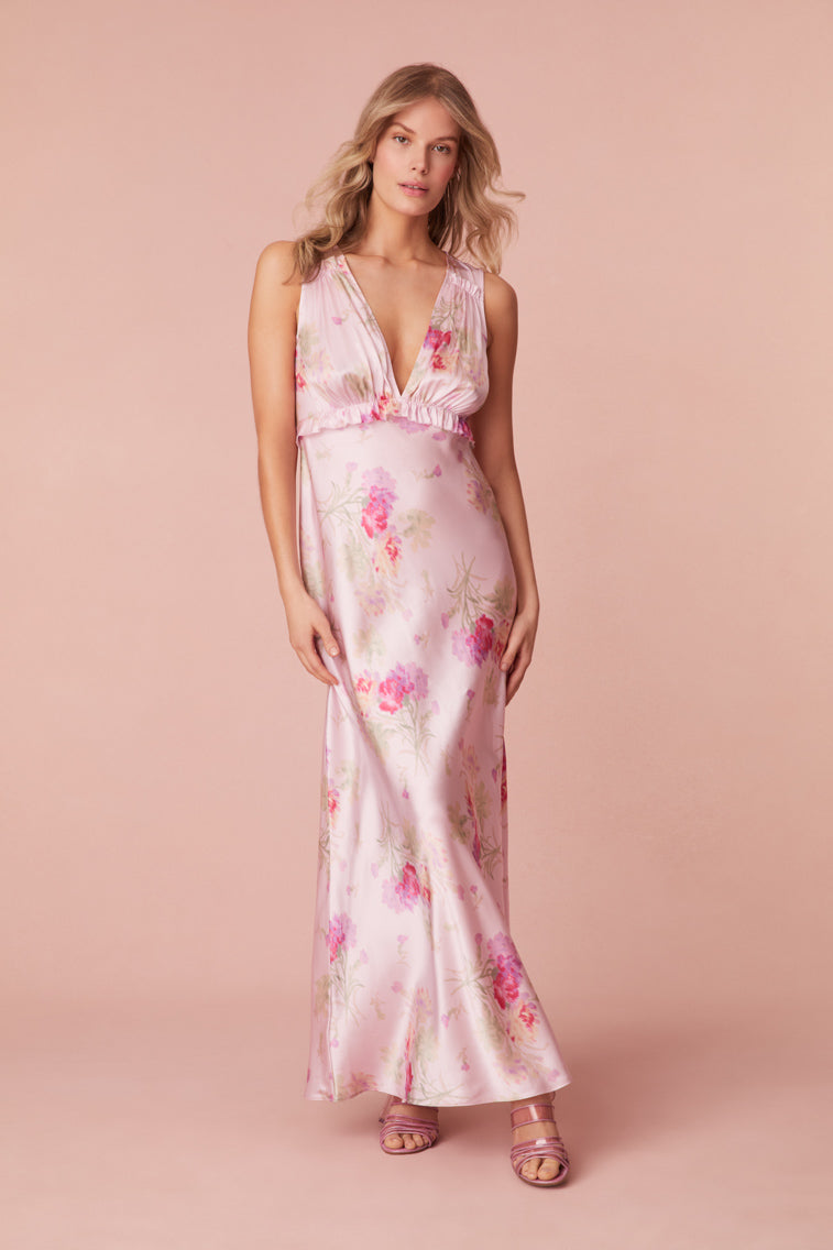 Floral printed maxi dress featuring a v-neckline, a ruched bodice, and a body-skimming skirt.