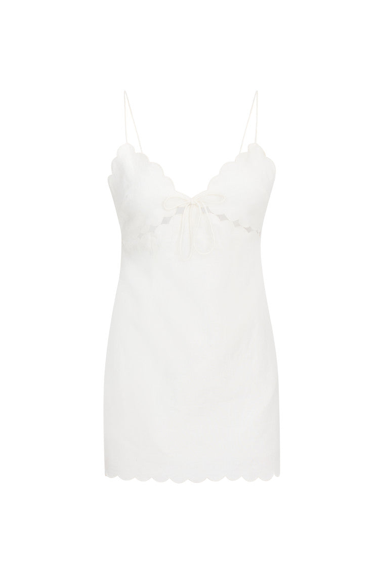 Linen mini dress with a fitted silhouette, thin spaghetti straps, cut outs at the top, scallop edges at the waist and a center back zipper.
