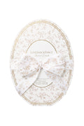 White and gold oval gift box with LoveShackFancy branding and bow ribbon, LoveShackFancy.