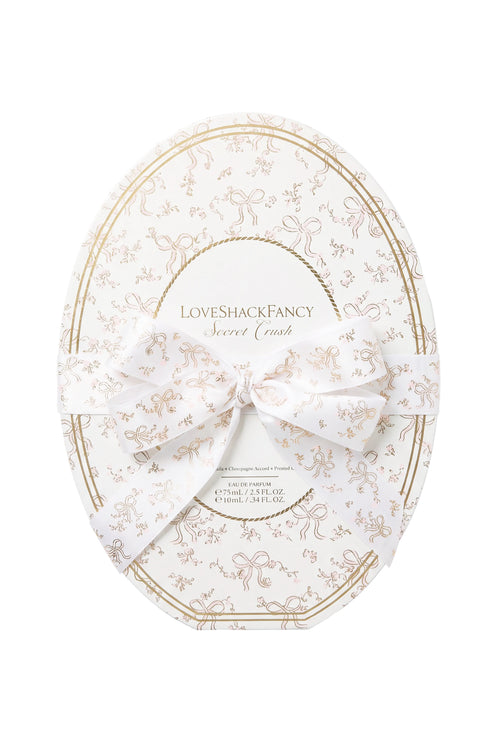 White and gold oval gift box with LoveShackFancy branding and bow ribbon, LoveShackFancy.