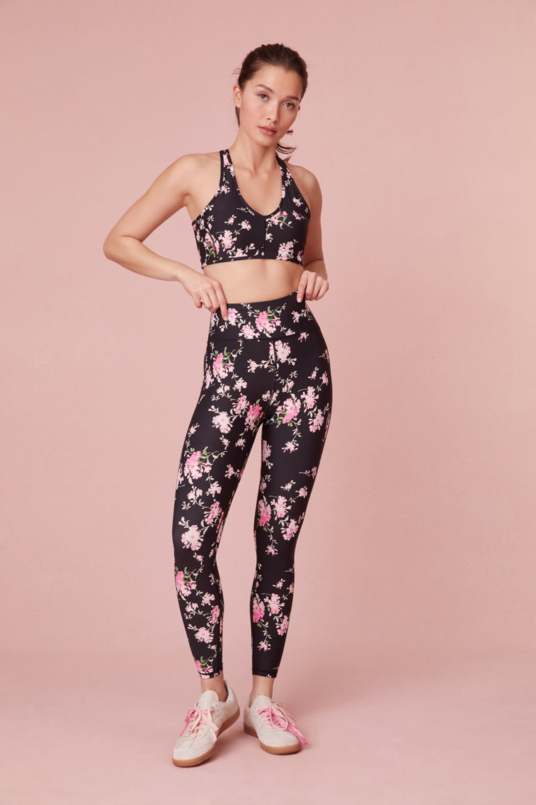 black with pink floral print Light Support - Sports Bra with u shape neckline and crossed back straps.