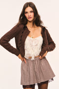Brown and beige plaid mini skirt with gathered waist and brown lace under layer visible at the hem, front view pose 4