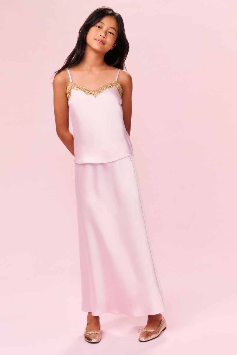 Women sitting in grass field wearing LoveShackFancy Slip Dresses
