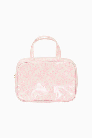 Pink textured cosmetic bag with handle on a white background