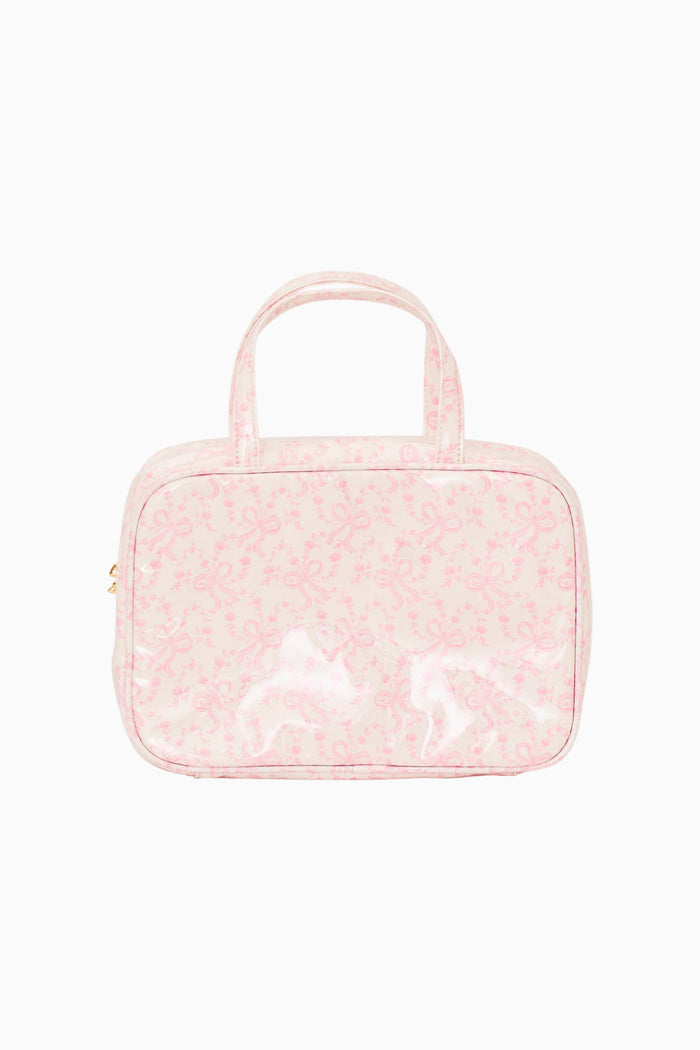 Pink textured cosmetic bag with handle on a white background