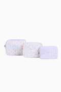 Three light blue travel cases with flower patterns on a white background