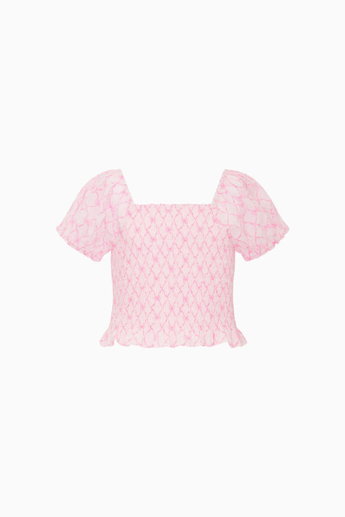 Pink blouse with bow pattern on a white background