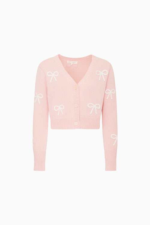 Pink cardigan with bow patterns on a white background