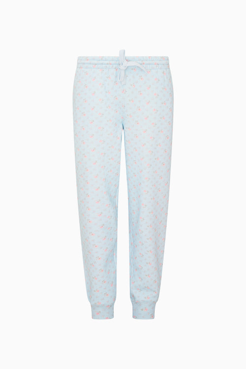 Light blue pajama pants with small colorful patterns on a white background