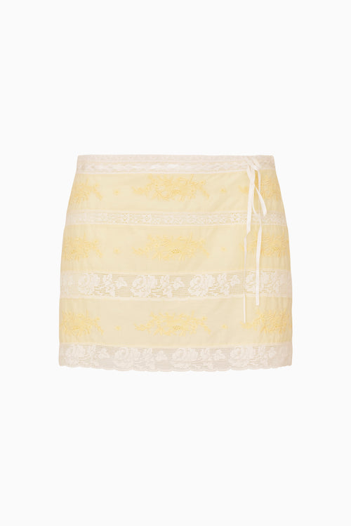 Yellow and white lace striped mini skirt with lace trim on a white background