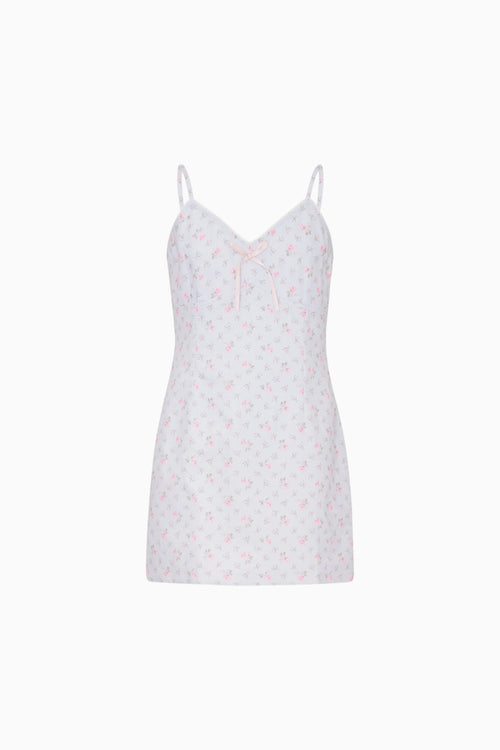 Blue slip dress with a subtle pattern on a white background