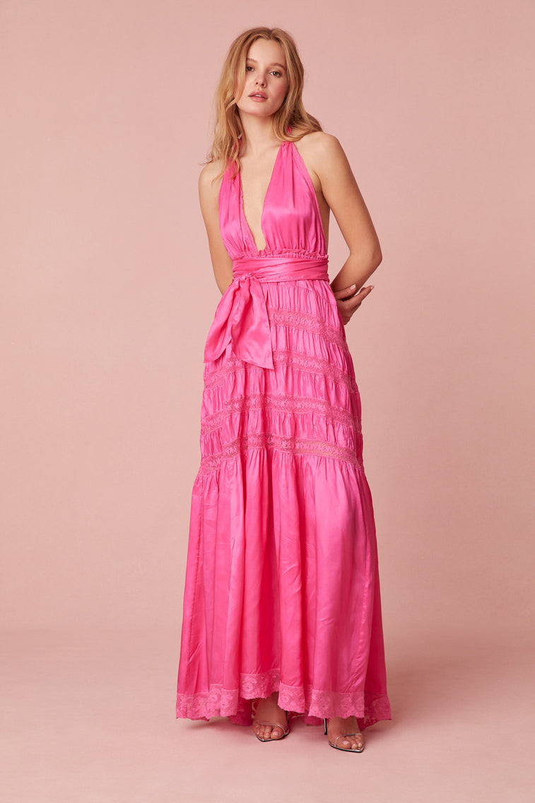 Pink maxi dress with a viscose fabric with laces and textural shirring details all over. Features a deep v-neck, an elasticated waist, and a dramatic skirt with shirring details.