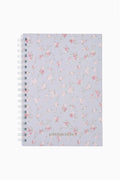 Floral patterned notebook with 'LOVE SHACK FANCY' branding on a light blue background