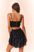 Black backless bow bustier top with adjustable straps and center back seam