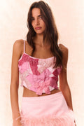 Pink bow bustier top with sequined patchwork front and ruffled bow detail