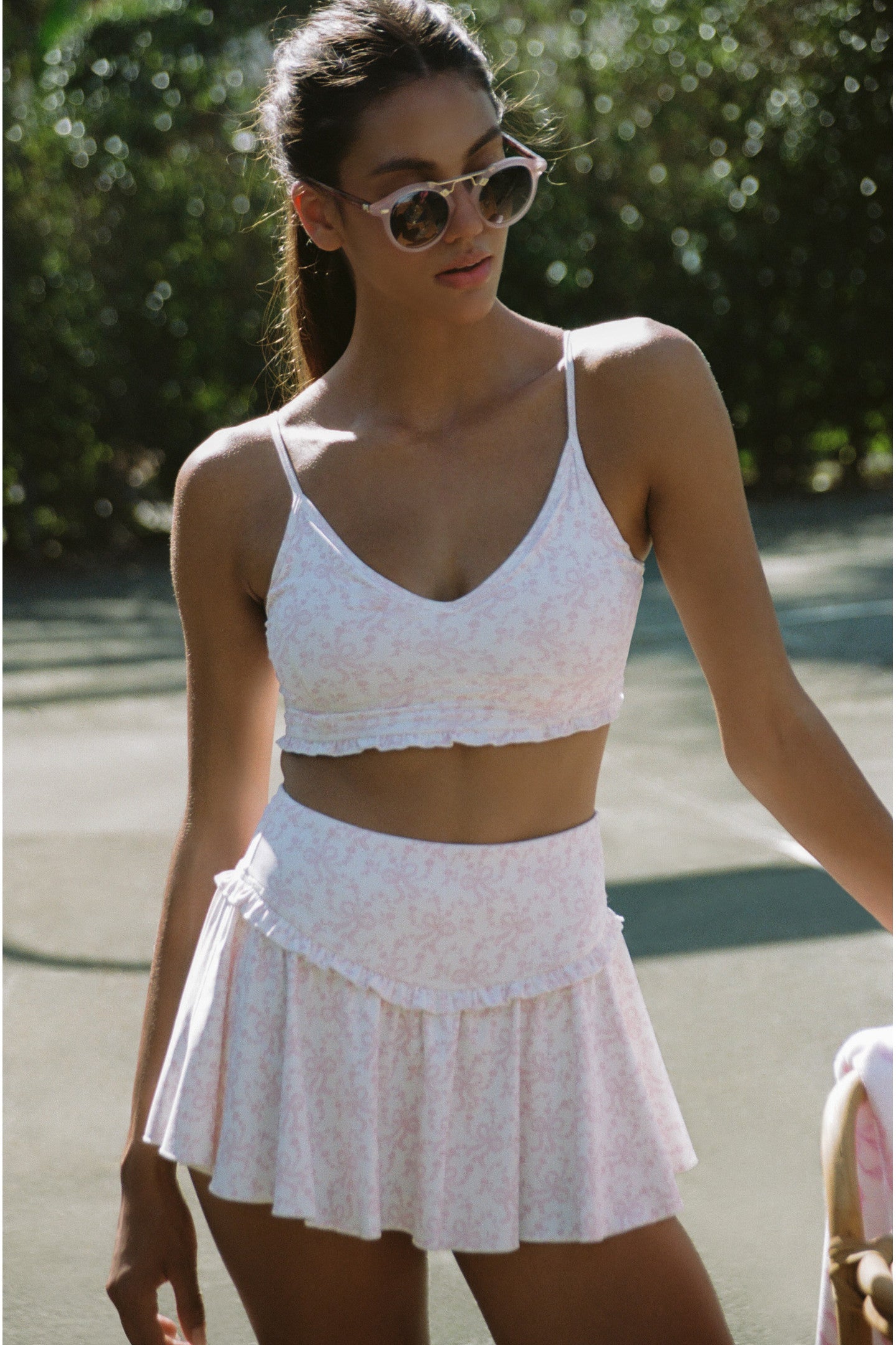 Women sitting in grass field wearing LoveShackFancy Slip Dresses