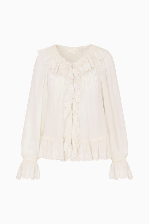 White blouse with ruffled details on a white background
