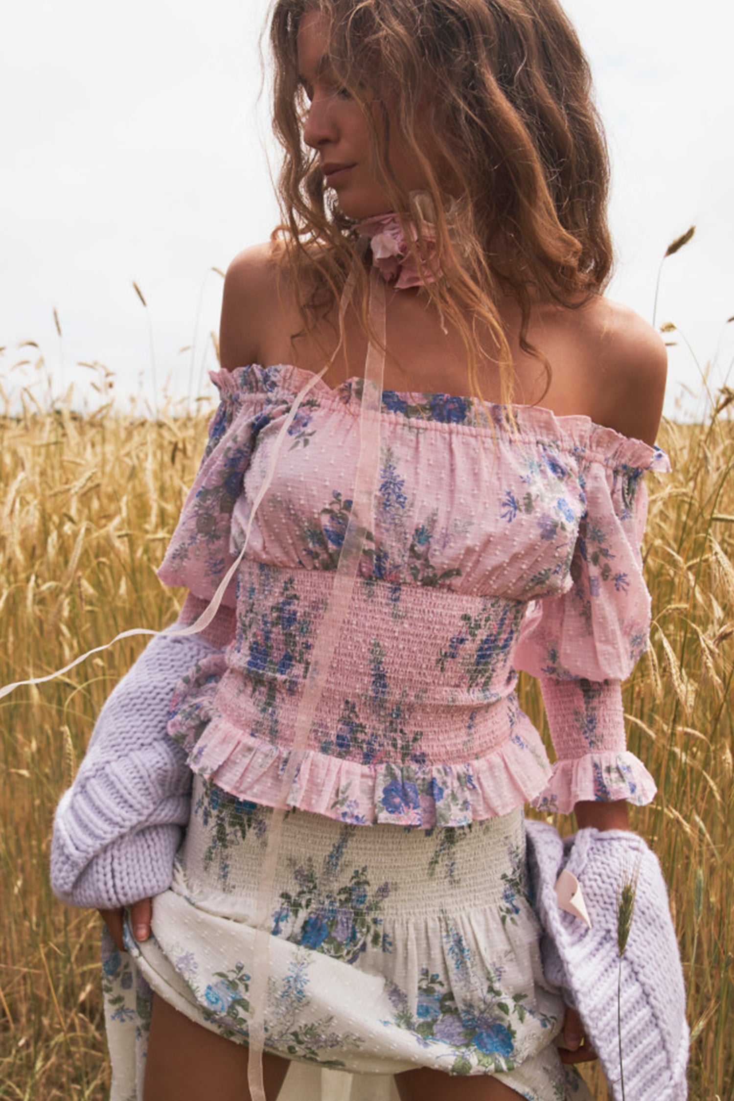 The Fifi top features an heirloom bouquet print on a soft textured dot cotton fabric with an elasticized opening at the shoulders and a smocking at the waist and sleeves.
