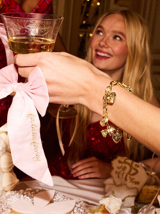 Women sitting in grass field wearing LoveShackFancy Slip Dresses