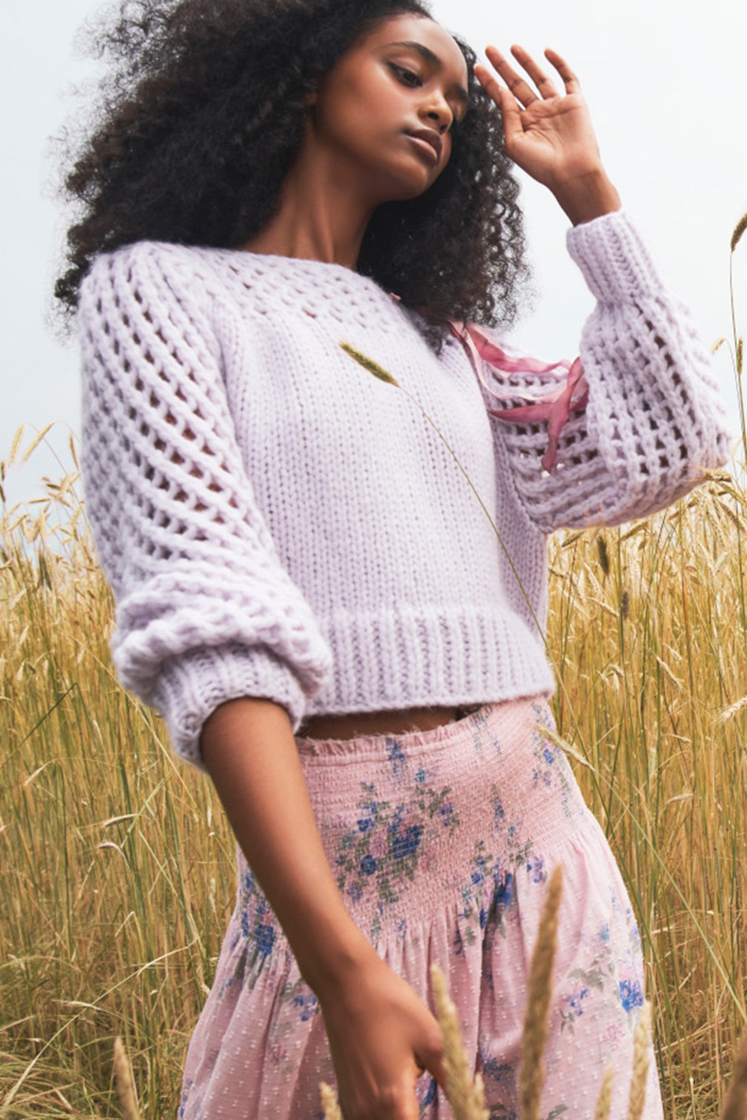 The Larson crop pullover in a soft purple is hand knitted from a Peruvian alpaca blend that features a silky feel and pointelle sleeves detailing underneath the boat neckline. It is slightly cropped a the hem