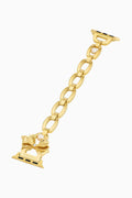 Gold chain bracelet with bow charm on a white background