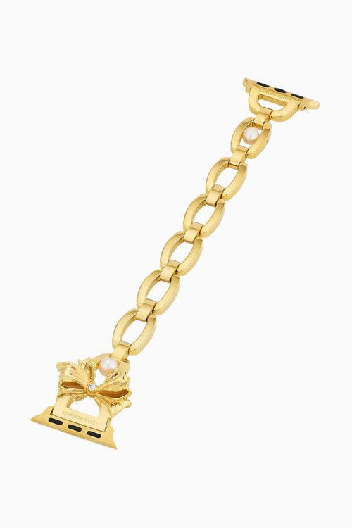 Gold chain bracelet with bow charm on a white background